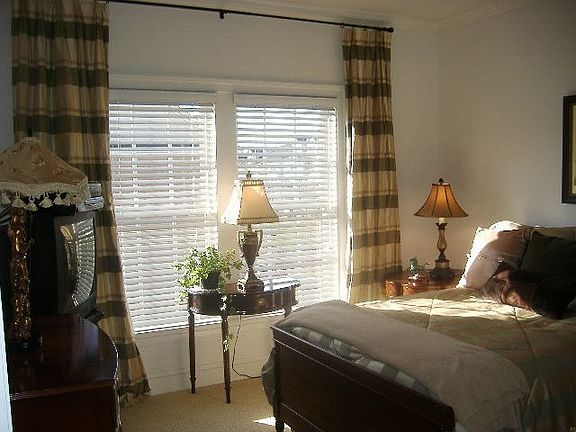 Generously sized 2nd Bedroom with custom drapes and blinds