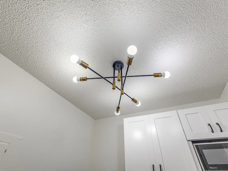 A simple modern light that brightens up the kitchen area.