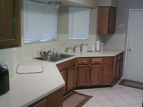 Kitchen features plenty of countertop space and tiled flooring.