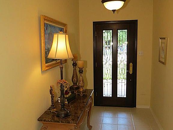Beveled Leaded Glass Panels in Mahogany Front Door, Elegant Bronze Entry Light