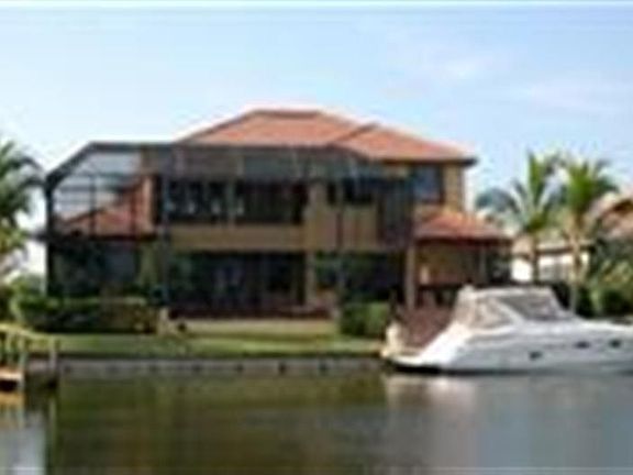 Back of home with boat being offered in Sale