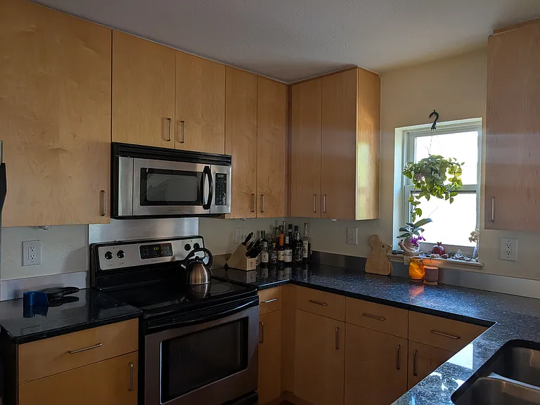 The bright, airy kitchen has lots of counter space and storage.