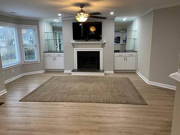 Large living room with tons of windows and natural light, recessed lighting throughout the home, crown, neutral paint, flat-scree w/Internet streaming services, built-ins, and fans in every room.