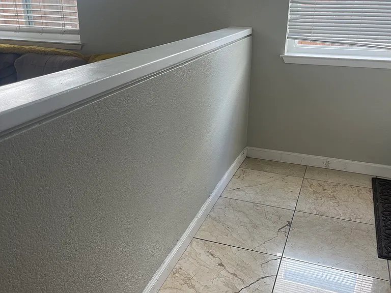At the front entrance, a step down off the marble tile that leads to the family room. Alternatively, you can turn left and go upstairs to the bedrooms.