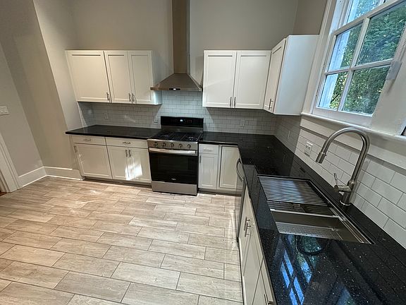 Fully renovated kitchen with granite countertops and all-new stainless steel appliances