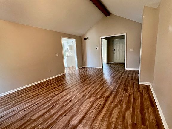 Other angle of the living area towards the front entryway.