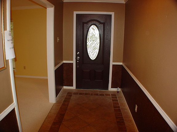 Leaded glass door and tiled entry.