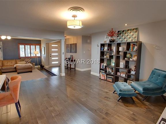 Front entry into sunken Formal Living Room with gas fireplace and Dining Room (also with 2nd gas fireplace!) with ceiling light 