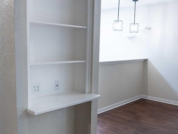 Cute built in shelves in the entryway between the dining area and living room