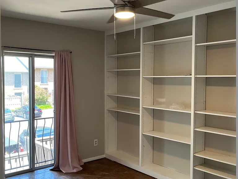 Bedroom 2 with built-in bookshelf, closet and new ceiling fan