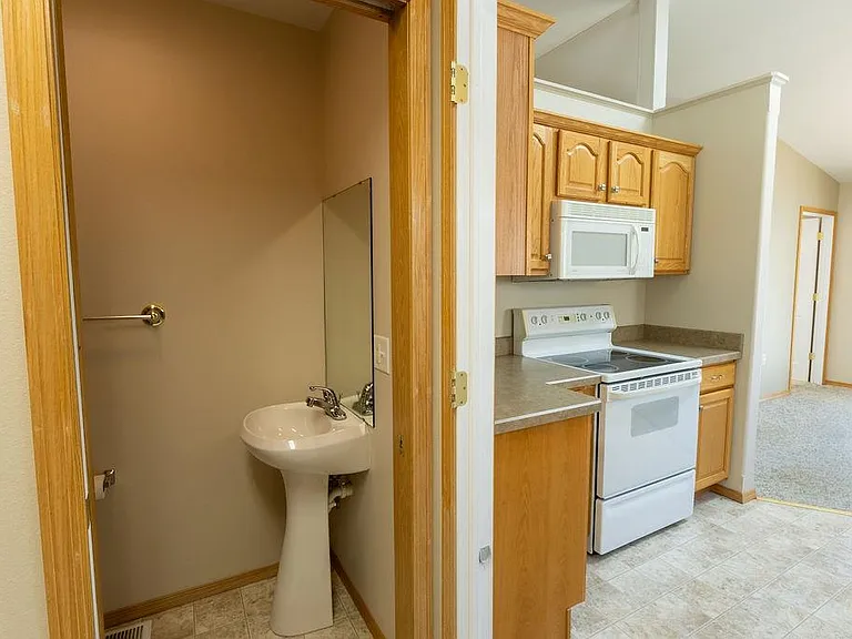 Door from garage, past a 3rd bathroom, looking to kitchen