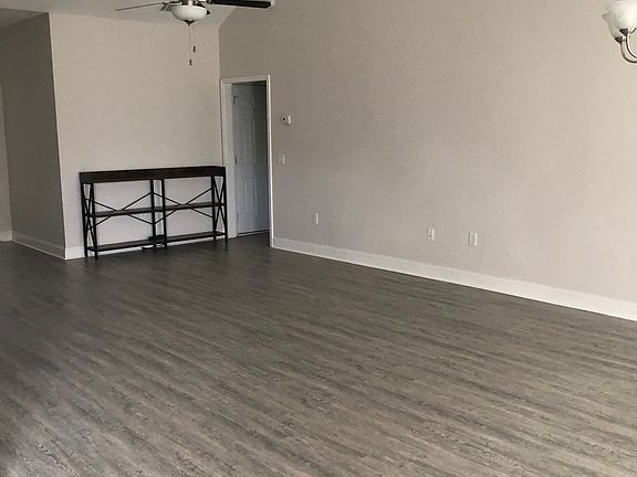 view of entrance on the right to the master bedroom, laundry area in hallway and exit to the two car garage