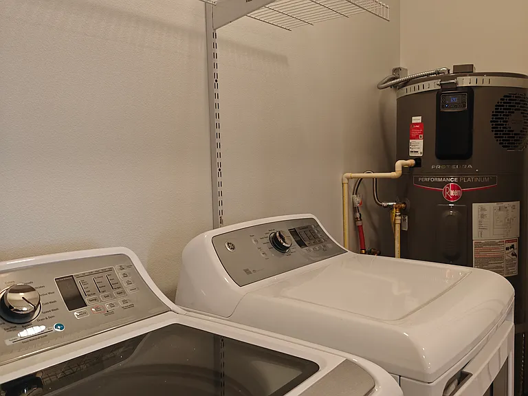W&D, water heater, and two shelves for storage.