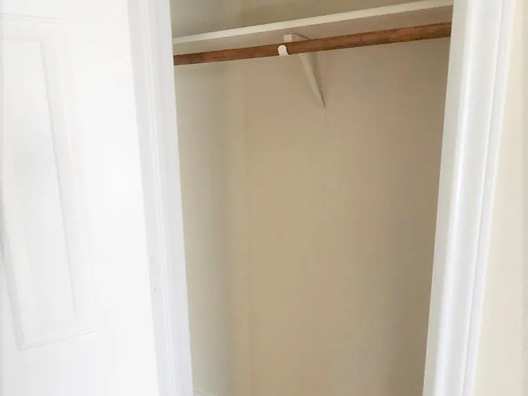One of two closets has a high bar for long garmets.