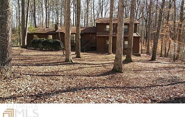 Curb appeal features full vista of only mature hardwood trees.