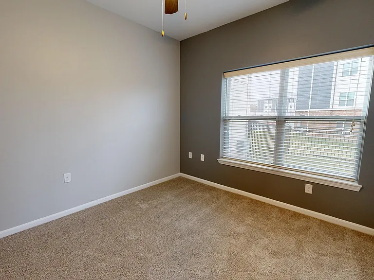 The second bedroom is located on the opposite side of the living space as the primary, providing extra privacy in The Redbud apartment. The second bedroom is located on the opposite side of the living space as the primary, providing extra privacy in The R