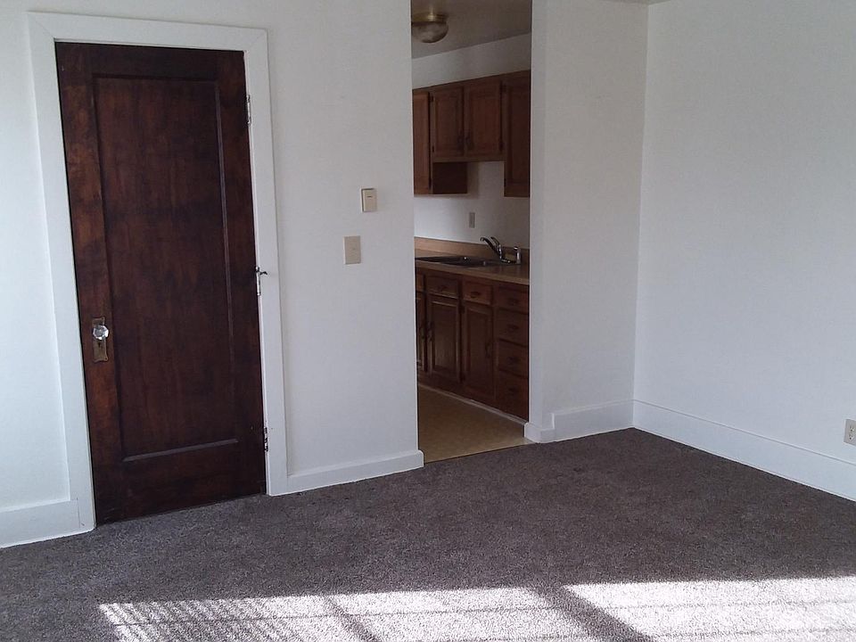 Living room with view of bathroom and kitchen