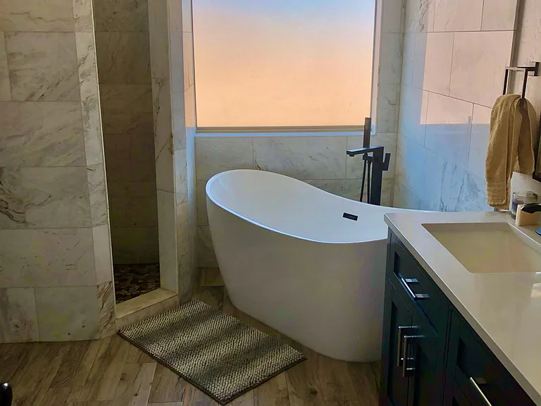 Renovated bathroom with freestanding tub. New flooring and vanities.