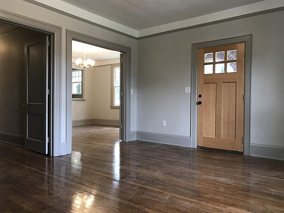 Living room with view of front door and dining room.