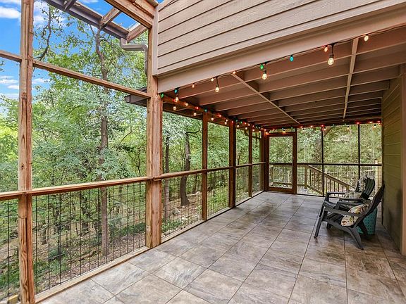 lower screened in porch. owl house in the oak off the porch with resident owls