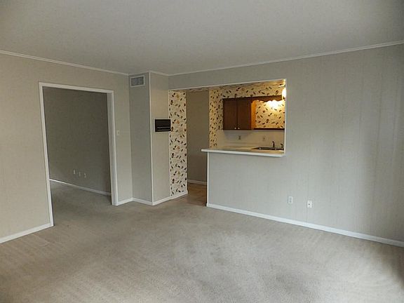 There is a breakfast bar between the kitchen and the den. The den looks out on the private back pati