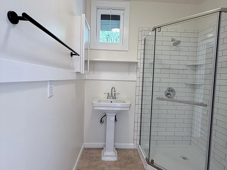 Renovated bathroom, new tile shower, new toilet, new accessories. Operable window in bathroom.