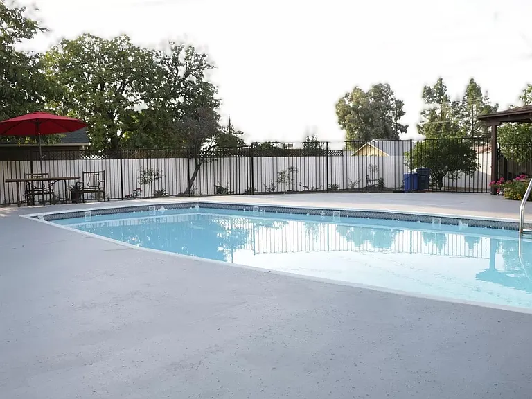 Enjoy the pool in the backyard patio area-- pool service is included with your lease