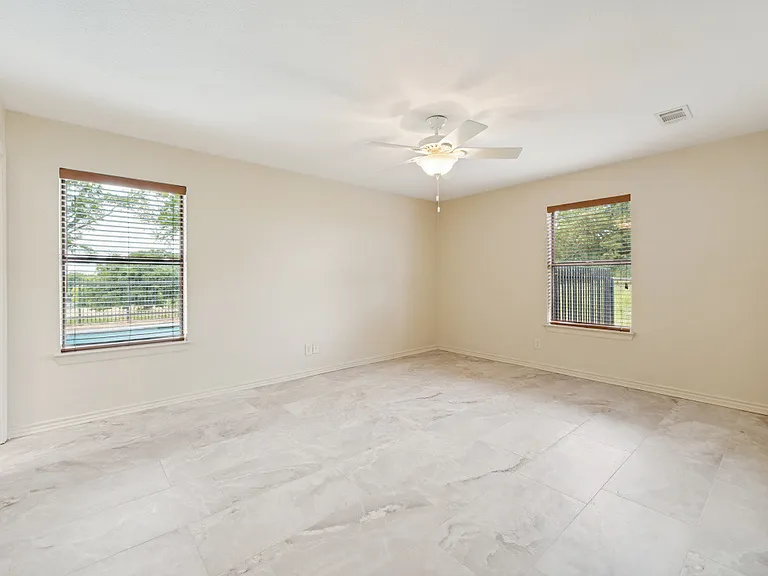 Spacious master bedroom with beautiful porcelain tile throughout bedroom and master bath.