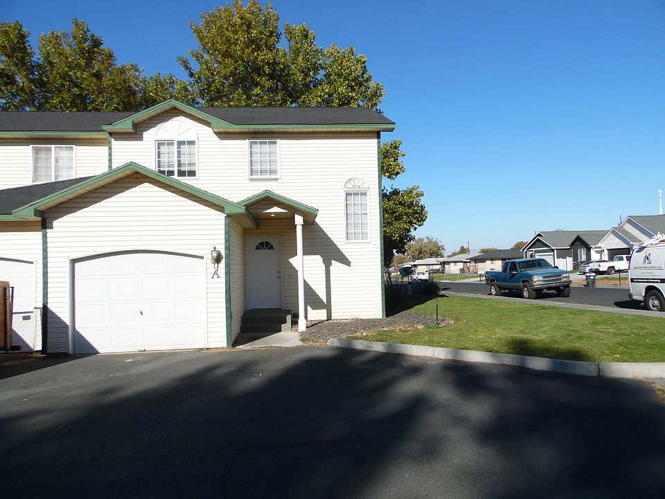 Corner unit with covered entry and remote access to garage. There is parking in front of the garage.