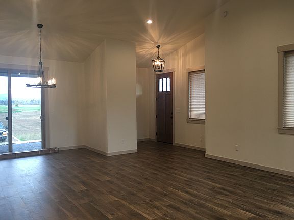 Great room with vaulted ceiling towards front door