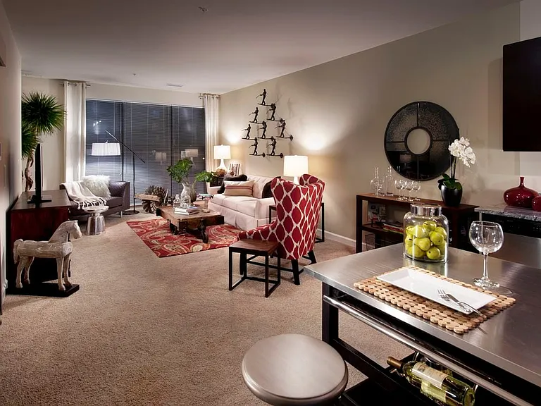 Open concept kitchen with movable island and living area with carpet