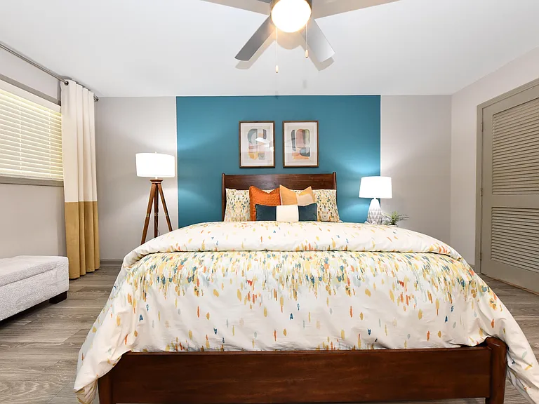 Cozy bedroom with hardwood-style flooring and ceiling fan