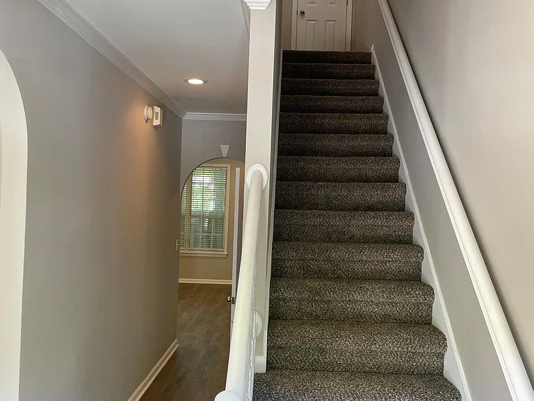 VIEW OF FRONT HALL AND STAIRS FROM FRONT DOOR.