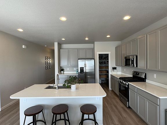 Upgraded kitchen with tons of natural light, cabinet space, quartz countertops, upgraded composite sink, large pantry and and gas range!