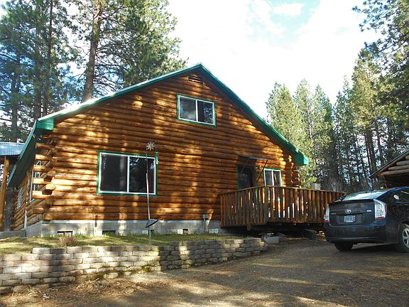 Driving up to log cabin