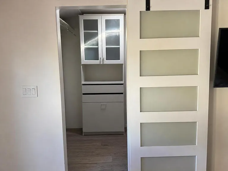 Master Bedroom walk in closet with solar tube.