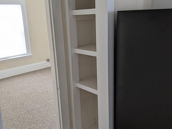 A thoughtful bookshelf to hold all your cookbooks, trivia books, and piles of mail :)