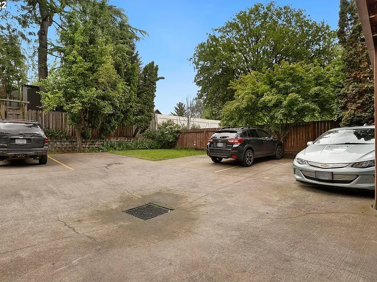 Backyard grassed area for relaxing or BBQ. Deeded parking space for Apartment A is on the left.