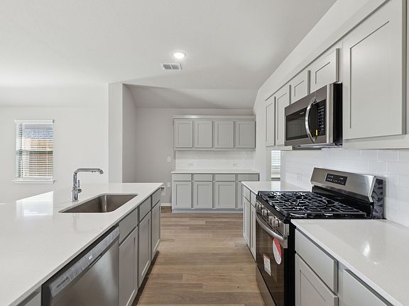 Kitchen in the Harrison home plan by Trophy Signature Homes - REPRESENTATIVE PHOTO