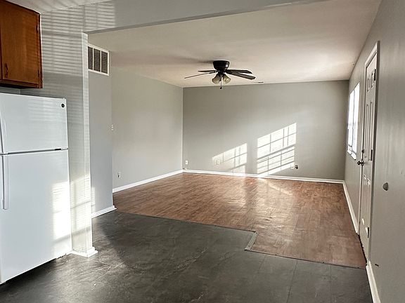 Spacious living area and kitchen with natural lighting.