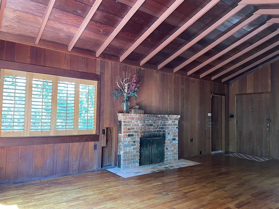Fireplace and open beam ceiling in living room great room.