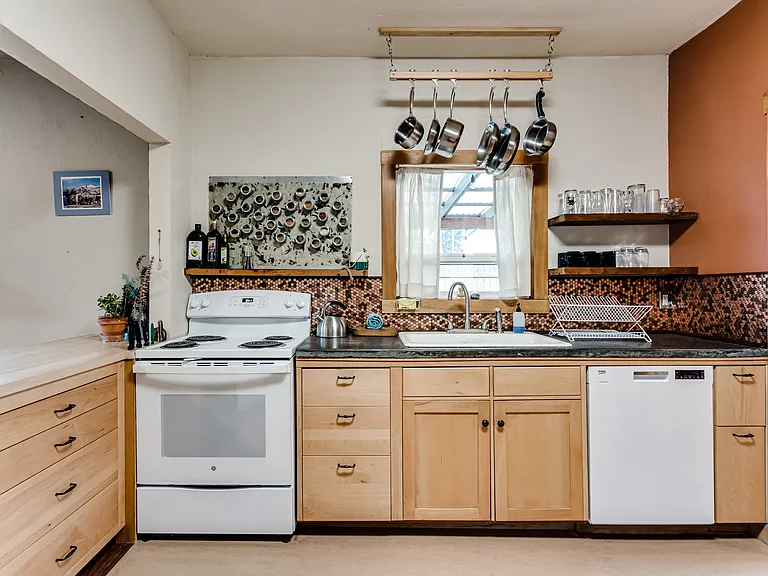 Kitchen is fully applianced with range/oven, dishwasher and fridge.