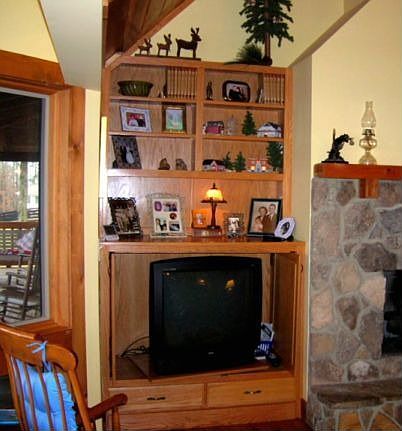 Bookcases flanking fireplace provide media cabinet