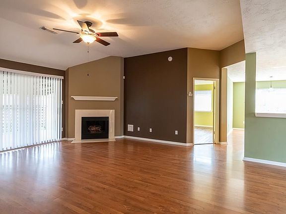 There's ceiling fans in all rooms. This view shows the den open to the kitchen.