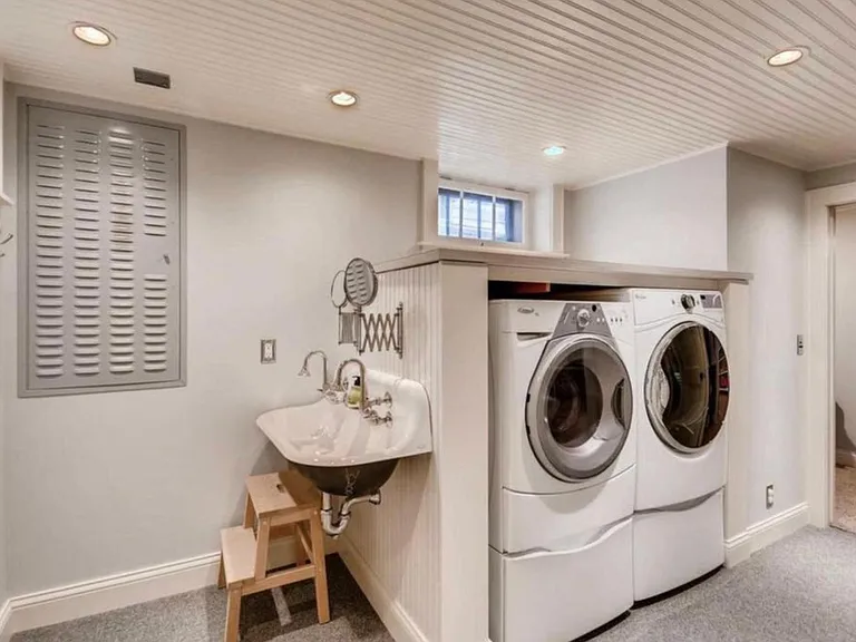 Large laundry and sink is a creative use of the space. Storage shelving is provided.