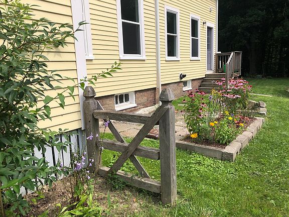 Side of building with seating/garden area