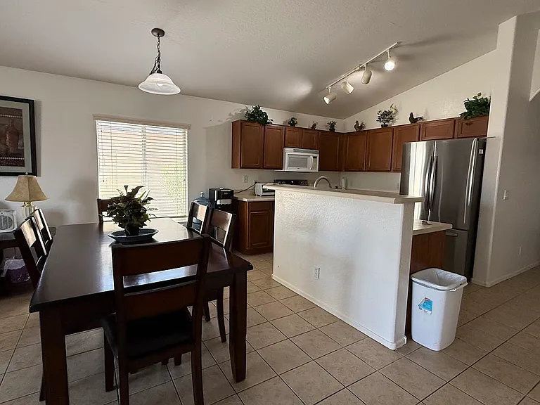 The kitchen has a new refrigerator, stove, and sink.