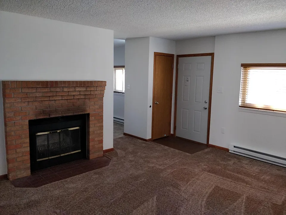 Living room looking back at the front door and dining area.