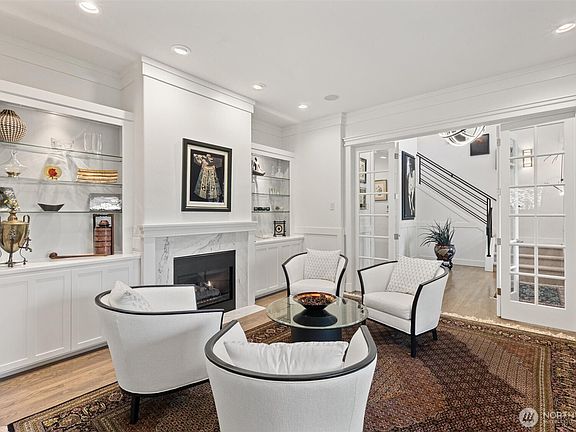 Formal living room with glass French doors and gas fireplace.>