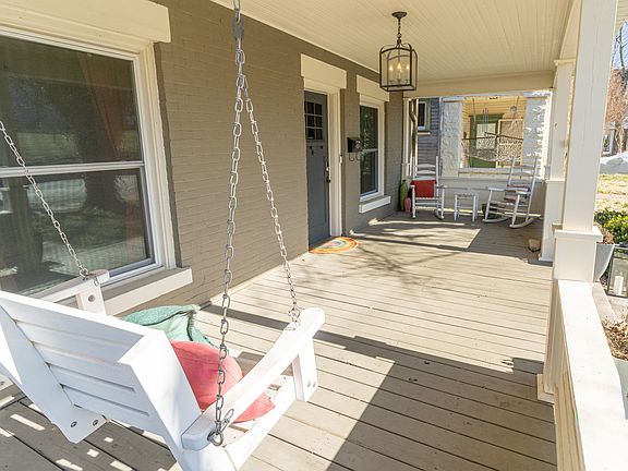 Sprawling covered front porch with seating.